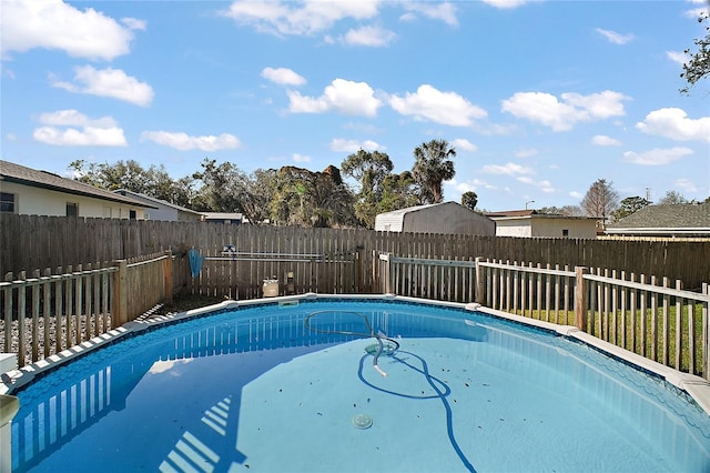 view of swimming pool with a fenced backyard and a fenced in pool