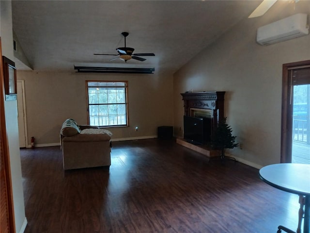 unfurnished living room featuring dark wood-type flooring, a glass covered fireplace, a wealth of natural light, and a wall mounted air conditioner