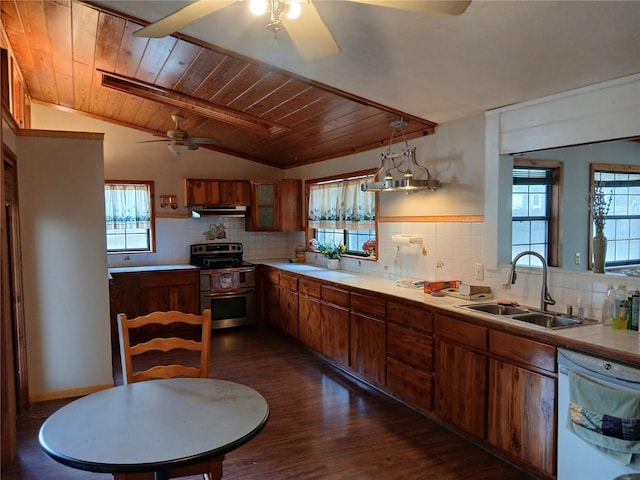 kitchen featuring a sink, double oven range, light countertops, and dishwasher