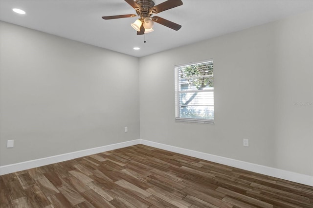 unfurnished room with recessed lighting, dark wood-style flooring, ceiling fan, and baseboards