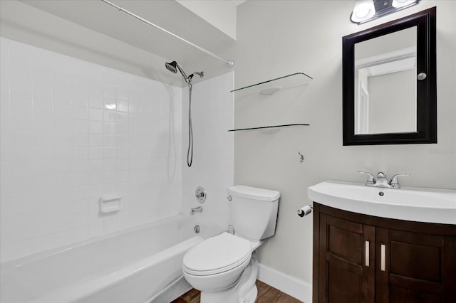 bathroom featuring baseboards, toilet, wood finished floors, vanity, and shower / bathing tub combination