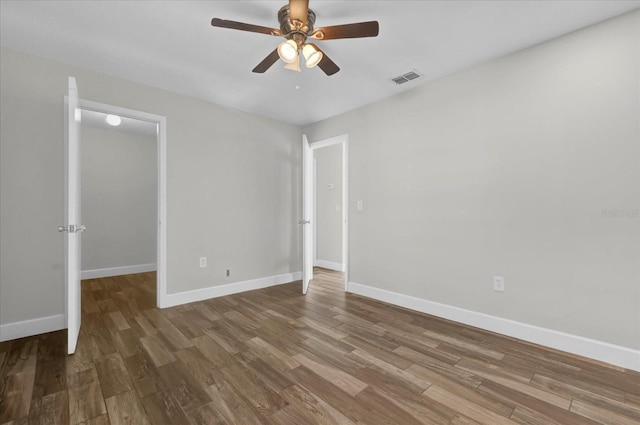 unfurnished bedroom with baseboards, visible vents, and wood finished floors