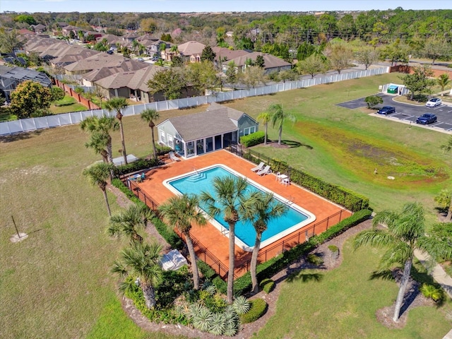 view of pool featuring an enclosed area, fence, and a residential view