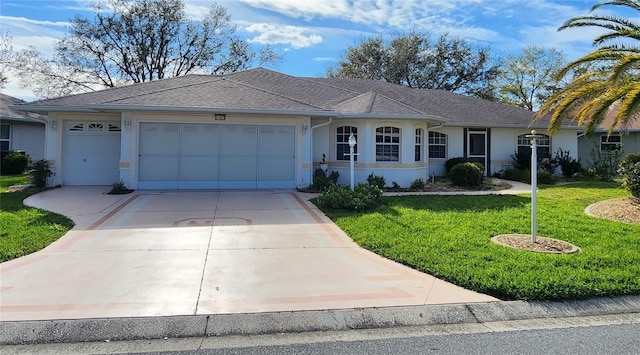 ranch-style home featuring stucco siding, a shingled roof, concrete driveway, an attached garage, and a front yard