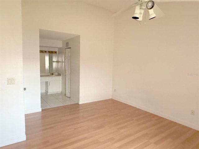 unfurnished room with light wood finished floors and ceiling fan