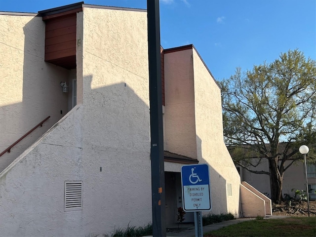 view of side of home with stucco siding