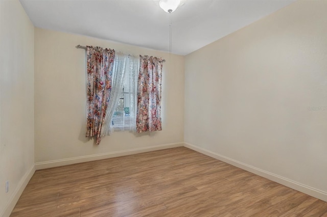 3368 Parkchester Square Blvd Unit 104, Orlando, FL 32835 - empty room featuring baseboards and light wood-style floors