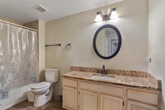 3368 Parkchester Square Blvd Unit 104, Orlando, FL 32835 - full bathroom with vanity, toilet, and wood finished floors