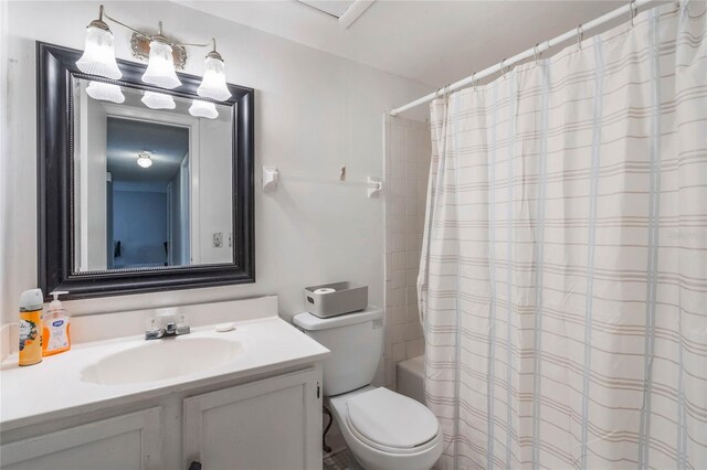 full bathroom featuring toilet, shower / bath combination with curtain, and vanity