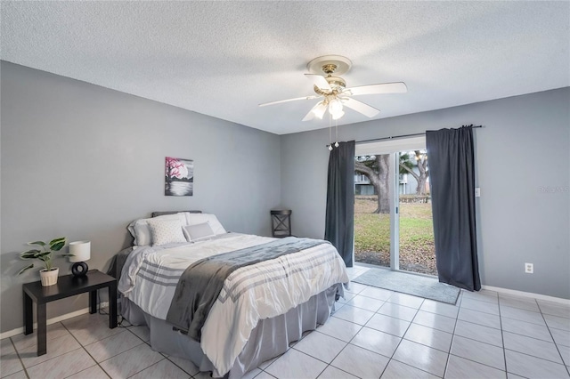 bedroom featuring a ceiling fan, a textured ceiling, baseboards, and light tile patterned floors