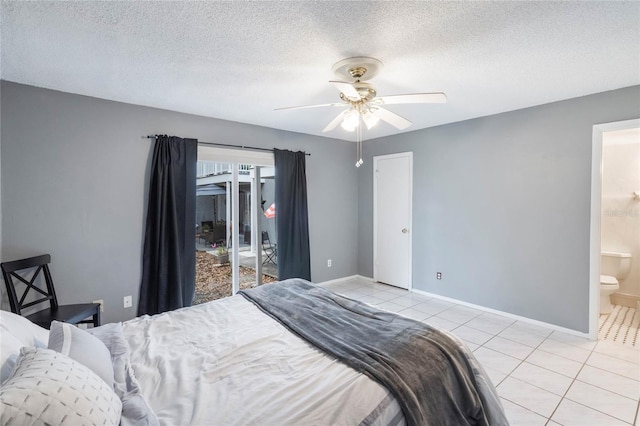 bedroom with light tile patterned floors, a textured ceiling, and baseboards