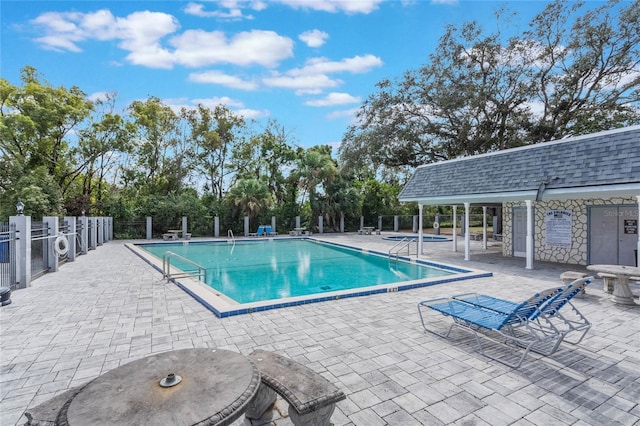 pool featuring a patio and fence