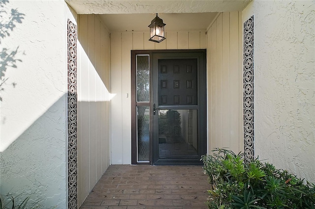 doorway to property with stucco siding