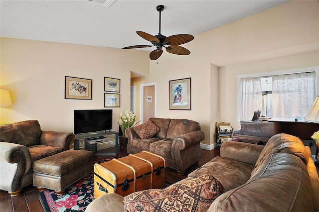 living area with lofted ceiling, ceiling fan, baseboards, and wood finished floors