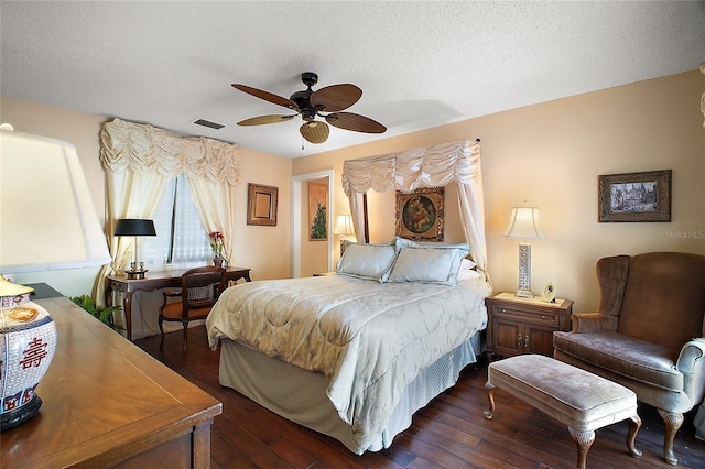 bedroom featuring a textured ceiling, a ceiling fan, and dark wood-style flooring