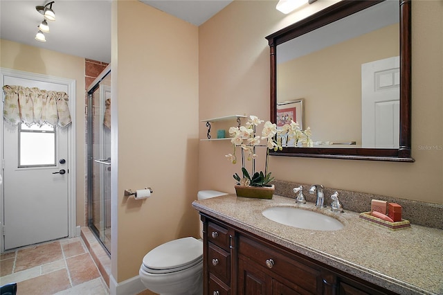 full bath with stone finish floor, a stall shower, vanity, and toilet