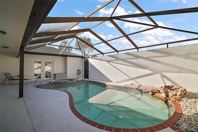 pool featuring french doors, glass enclosure, and a patio