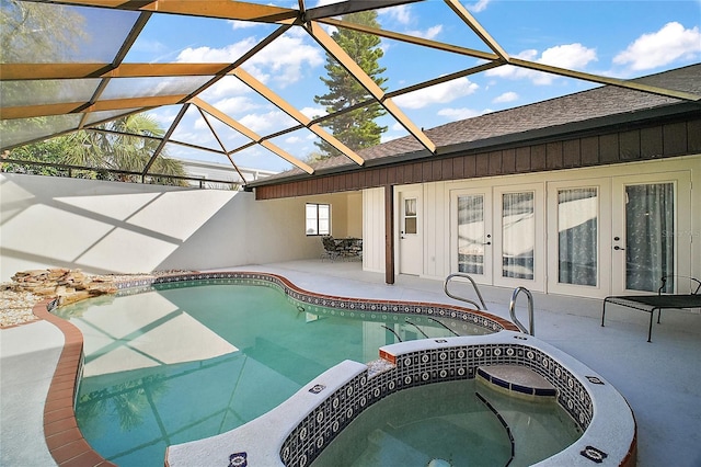 pool featuring an in ground hot tub, french doors, a patio area, and a lanai