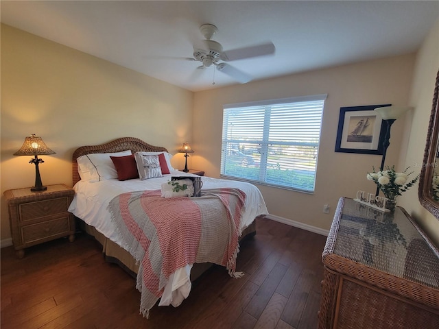 bedroom featuring ceiling fan, dark wood-type flooring, and baseboards