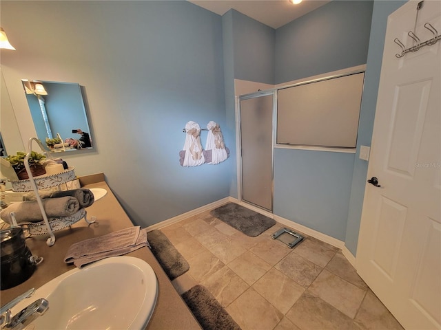 full bathroom with baseboards, a sink, and a shower stall