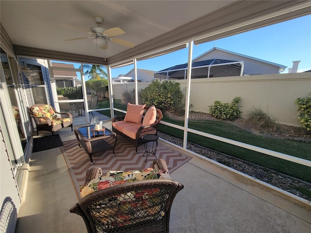 sunroom featuring ceiling fan