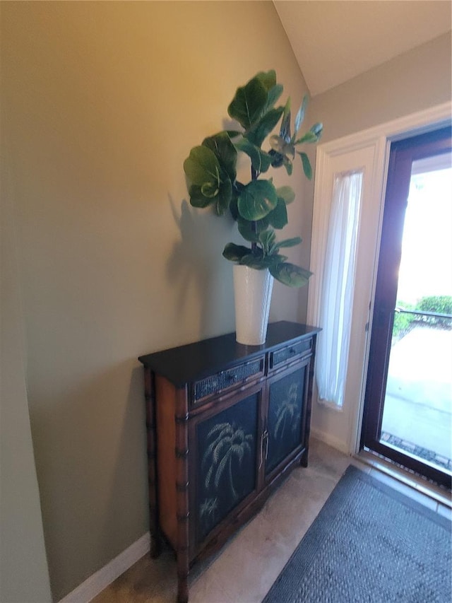 doorway with light carpet and baseboards