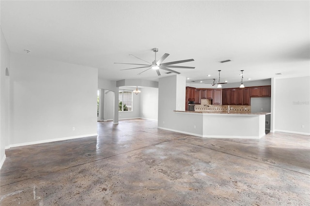 unfurnished living room with ceiling fan with notable chandelier, concrete floors, visible vents, and baseboards