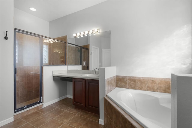 full bathroom featuring a stall shower, vanity, a bath, and tile patterned floors