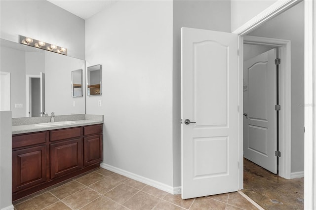 bathroom with tile patterned flooring, vanity, and baseboards