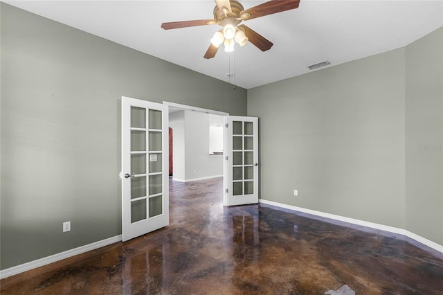 spare room featuring baseboards, visible vents, concrete flooring, and french doors