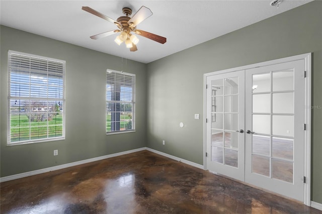 empty room with baseboards, french doors, a ceiling fan, and finished concrete floors