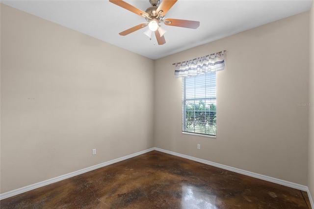 empty room featuring ceiling fan, baseboards, and concrete flooring