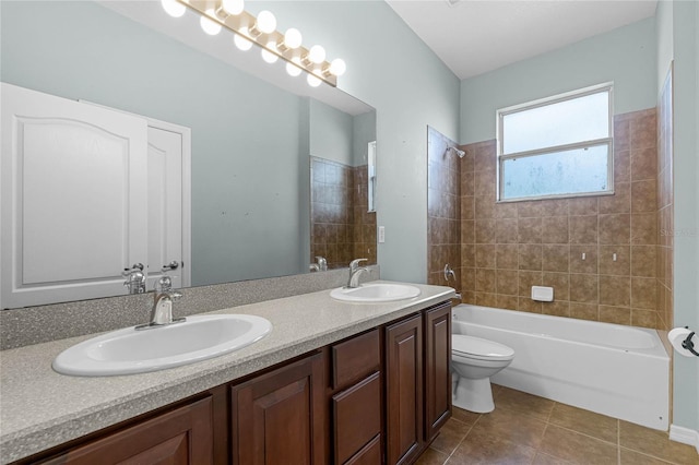 full bath with toilet, bathing tub / shower combination, a sink, and tile patterned floors