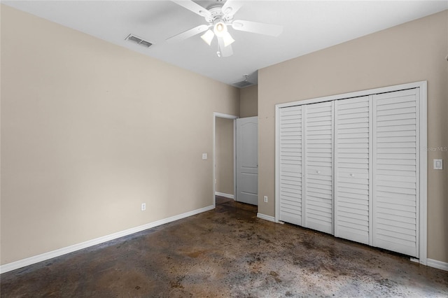 unfurnished bedroom with baseboards, visible vents, ceiling fan, concrete flooring, and a closet