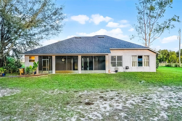 back of house with roof with shingles and a yard