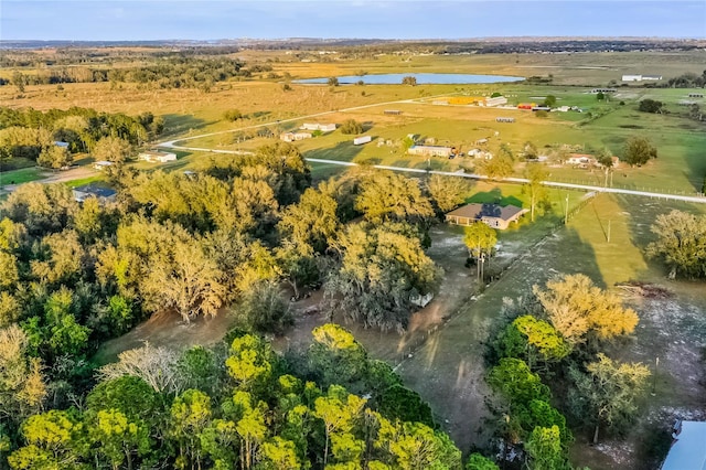 birds eye view of property with a water view and a rural view