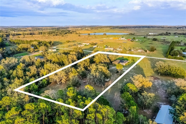 birds eye view of property with a water view and a rural view