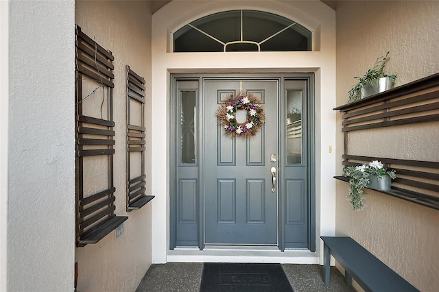 entrance to property with stucco siding