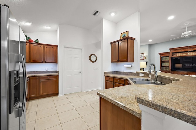 kitchen with stainless steel refrigerator with ice dispenser, visible vents, a ceiling fan, light tile patterned flooring, and a sink