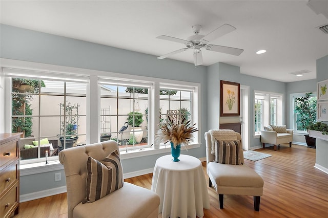 sitting room with visible vents, baseboards, a ceiling fan, light wood-style floors, and recessed lighting