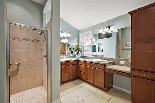 full bath with vaulted ceiling, a tile shower, a sink, and tile patterned floors