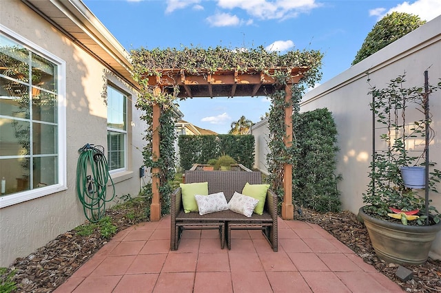 view of patio featuring fence and a pergola