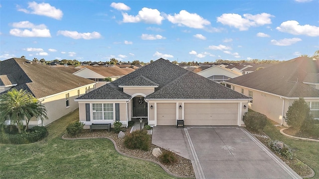 ranch-style house with a garage, concrete driveway, roof with shingles, stucco siding, and a front lawn