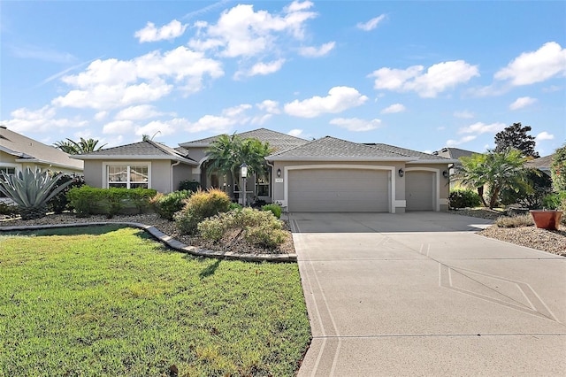 single story home featuring a garage, a front yard, concrete driveway, and stucco siding