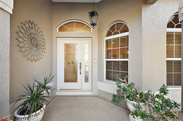 property entrance featuring stucco siding