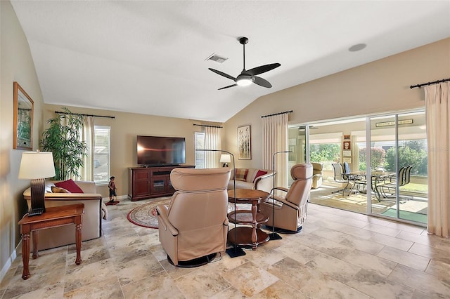 living area with a ceiling fan, visible vents, vaulted ceiling, and baseboards