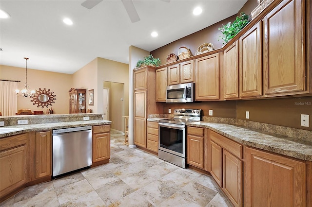 kitchen with recessed lighting, ceiling fan with notable chandelier, stainless steel appliances, light countertops, and pendant lighting