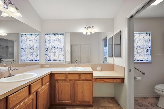 full bath with a sink, toilet, and double vanity