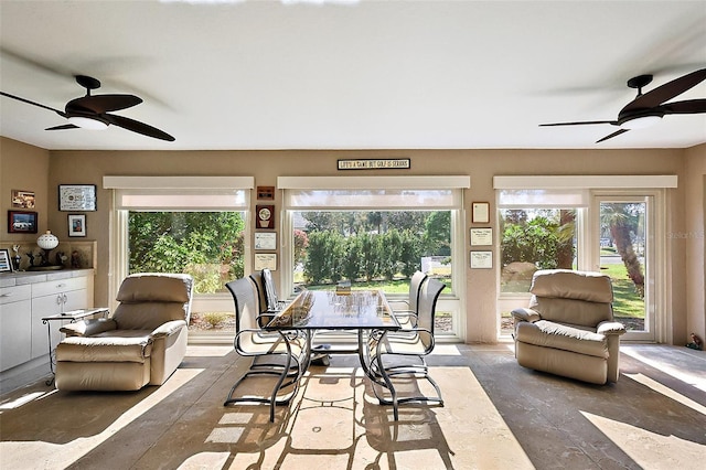 sunroom featuring ceiling fan