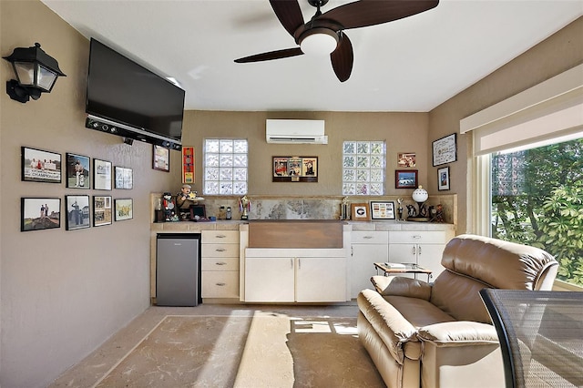 bar featuring a wall unit AC, ceiling fan, and freestanding refrigerator